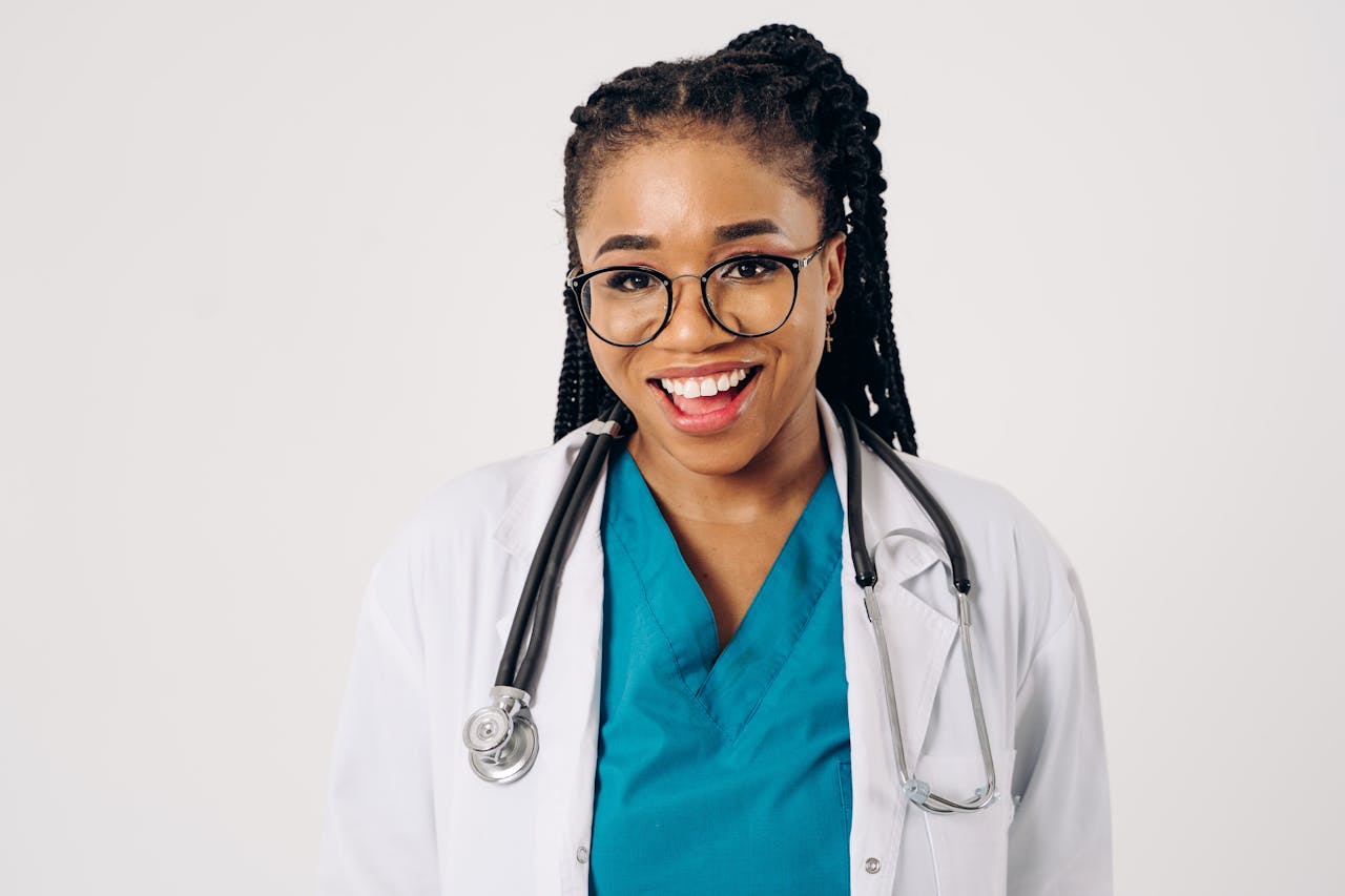 Smiling female doctor in lab coat with stethoscope